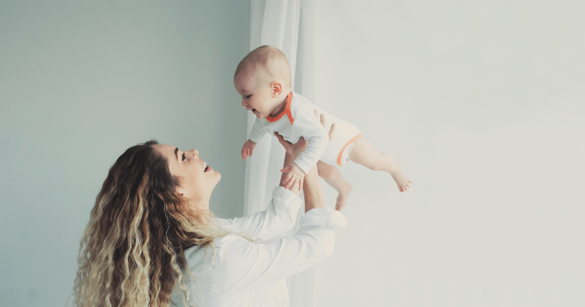 a mother holding her child in the air